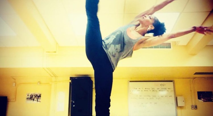 A person doing an acrobatic pose in the middle of a room.